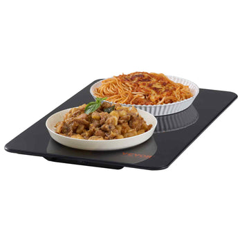 Black induction cooktop with a sleek design, featuring a plate of spaghetti and a bowl of chicken dish.