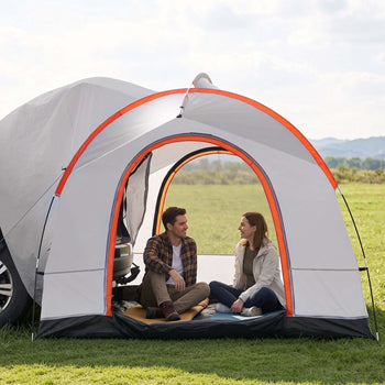 Gray and orange pop-up camping tent with an open entrance, ideal for outdoor relaxation, featuring two people inside.