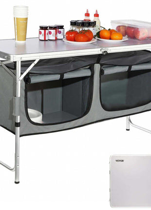 Gray collapsible camping table with storage compartments, aluminum frame, and a white tabletop, perfect for outdoor use.