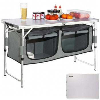 Gray collapsible camping table with storage compartments, aluminum frame, and a white tabletop, perfect for outdoor use.