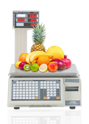 Digital fruit scale with a stainless steel platform, featuring colorful fruits like pineapple, bananas, and apples.