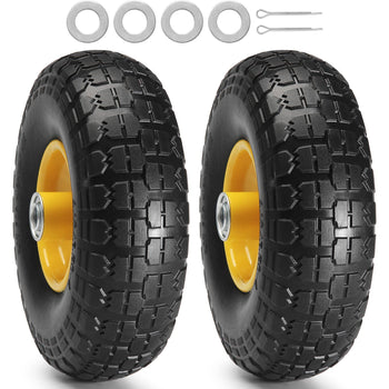 Black all-terrain tires with yellow rims, featuring a rugged tread pattern and accompanied by spacers and pins.