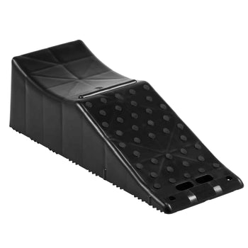 Black ergonomic footrest with a textured surface and a sloped design for improved posture and comfort.