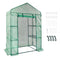 Green polyethylene greenhouse with metal frame, shelving, and accessories for secure outdoor gardening.